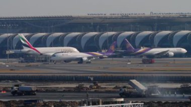 BANGKOK, THAILAND - JANUARY 19, 2023: Airbus A350 of Thai Airways taxiing at Suvarnabhumi Airport. Passenger flight on apron, terminal in the background. Tourism and travel concept