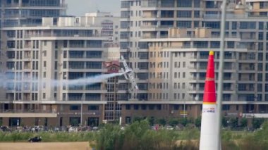 KAZAN, RUSSIAN FEDERATION, JUNE 15, 2019: Red Bull airplane races at Red Bull Air Races. Tricks and aerobatics in the air. Racing sports aircraft on the background of the city