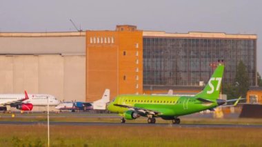 NOVOSIBIRSK, RUSSIAN FEDERATION - JUNE 17, 2020: Embraer E170, VQ-BYW of S7 Airlines speed up before take off at Tolmachevo Airport, side view. Tourism and travel concept