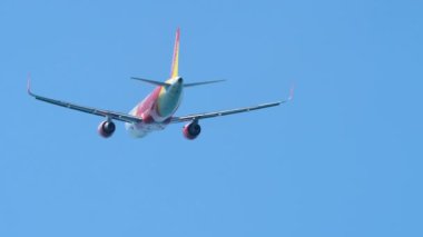 PHUKET, THAILAND - JANUARY 22, 2023: Airbus A320 of VietJet take off at Phuket airport. Airliner fly overhead. Airplane departure, climbing, rear view. Travel concept