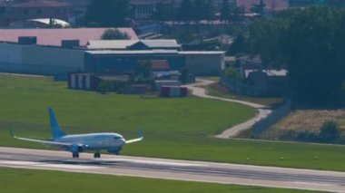 SOCHI, RUSSIA - JULY 28, 2022: Passenger airplane Boeing 737 of Pobeda arrival, braking after landing at Sochi airport, side view. Tourism and travel concept