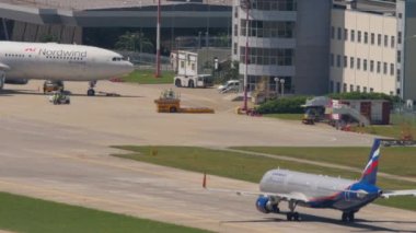 SOCHI, RUSSIA - JULY 28, 2022: Airbus A320 of Aeroflot taxiing at Sochi airport. Airplane on the airfield, rear view. Tourism and travel concept