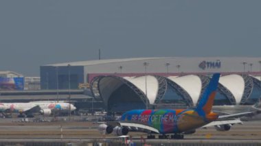 BANGKOK, THAILAND - JANUARY 19, 2023: Airbus A380 of Emirates braking after landing at Suvarnabhumi airport, side view. Tourism travel concept