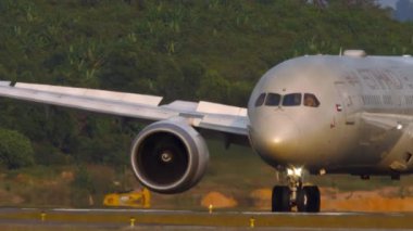 PHUKET, THAILAND - JANUARY 22, 2023: Passenger plane of ETIHAD taxiing at Phuket airport. Airplane on the runway