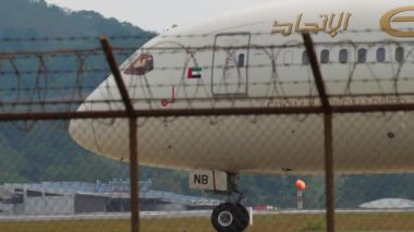 PHUKET, THAILAND - JANUARY 30, 2023: Plane Boeing 787-9 Dreamliner, A6-BNB of Etihad Airways taxiing at Phuket airport. Airplane on the runway