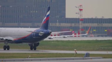 MOSCOW, RUSSIAN FEDERATION - JULY 28, 2021: Aeroflot plane taxiing to runway, departing flight at Sheremetyevo airport. Aircraft riding, side view. Tourism and aviation concept