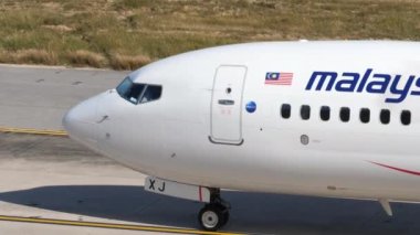 PHUKET, THAILAND - FEBRUARY 06, 2023: Close up shot of Boeing 737-8H6, 9M-MXJ of Malaysia Airlines taxiing after landing at Phuket Airport. Airplane arriving, side view.