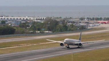 PHUKET, THAILAND - FEBRUARY 07, 2023: Widebody Boeing 777-3M0ER, RA-73134 of Aeroflot Skyteam livery taking off at Phuket airport, side view. Jet aircraft departure. Tourism and travel concept