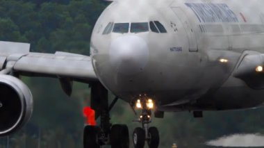 PHUKET, THAILAND - JANUARY 24, 2023: Airplane Airbus A330 of Turkish Airlines taxiing, turning at Phuket Airport. Passenger flight, airfield through the fence. Tourism travel concept