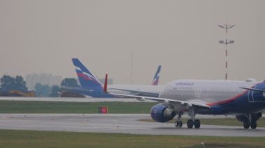 MOSCOW, RUSSIAN FEDERATION - JULY 28, 2021: Airbus A320 of Aeroflot taxiing on the runway, rear view. Tourism and travel concept
