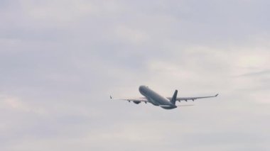 PHUKET, THAILAND - JANUARY 31, 2023: Rear view of Airbus A330 Qatar Airways takes off, climb at Phuket airport. Passenger flight departure. Tourism and travel concept