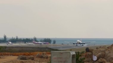 PHUKET, THAILAND - JANUARY 29, 2023: Airplane of Turkish Airlines landing and braking at Phuket airport. Airplane flies over the sea, beach