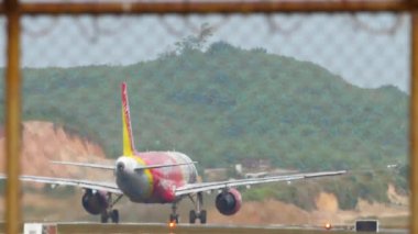 PHUKET, THAILAND - JANUARY 31, 2023: Airbus A320 of VietJet Air Sky Boss Livery take off, departure at Phuket Airport. Jet plane accelerates, flies away