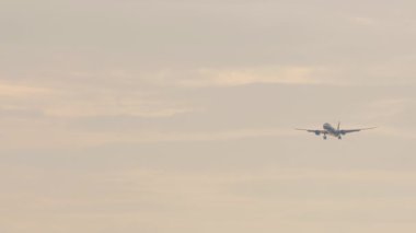 Jet unrecognizable aircraft approaching for landing. Footage of an airliner in the sky. Tourism and travel concept. Airplane Silhouette