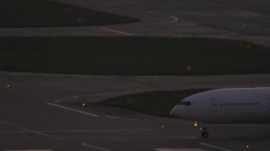 Widebody passenger aircraft taxiing on the taxiway. Airliner rides to the runway. Tourism and travel concept