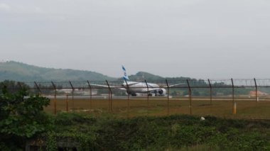PHUKET, THAILAND - JANUARY 31, 2023: Boeing 787 Dreamliner of El Al take off at Phuket Airport, rear view. Long shot of jet plane departure. El Al airline Israel. Tourism and travel concept