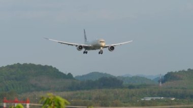 PHUKET, THAILAND - 11 Şubat 2023: Boeing 787-9 Dreamliner, Etihad Havayollarının A6-BLX 'i Phuket havaalanına indi. Yeşil tepelerin arka planında modern jet uçakları. Turizm ve seyahat kavramı