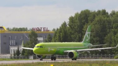 NOVOSIBIRSK, RUSSIAN FEDERATION - JULY 15, 2022: Airbus A321 of S7 Airlines taxiing at Tolmachevo airport. Side view, aircraft on the taxiway. Tourism and travel concept