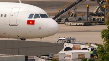 PHUKET, THAILAND - 25 Şubat 2023: Phuket Havaalanı 'nda VietJetAir Airbus A320' yi çeken römork. Sivil bir uçağın kokpitinde orta ölçekli bir çekim. Turizm ve seyahat kavramı