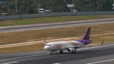 PHUKET, THAILAND - 13 Şubat 2023: Sivil uçak Airbus A320, Phuket havaalanındaki terminale taksicilik yapan Taylandlı HS-TXM. Yolcu uçağı taksi yolunda.