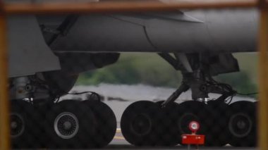 Aircraft jet engine close-up, airplane chassis. Wheels rubber tire rear landing gear racks airplane aircraft, under wing view