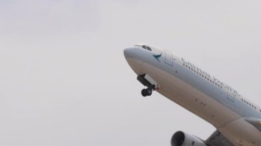 PHUKET, THAILAND - 13 Şubat 2023: Cathay Pacific 'in sivil uçak Airbus' u A330 kalkış ve iniş takımlarını Phuket Havalimanı 'ndan geri çekin. Yolcu uçağının kalkış görüntüleri. Turizm ve seyahat kavramı