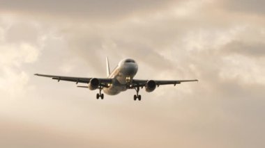 PHUKET, THAILAND - 16 Şubat 2023: Jet uçağı Thai gülümsemesi gün batımında uçar. Uçak geliyor. Bulutlu alacakaranlık gökyüzüne inmeden önce bir uçak yaklaşıyor.