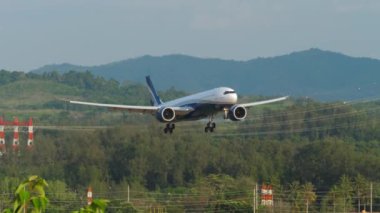 PHUKET, THAILAND - FEBRUARY 11, 2023: Commercial plane of Sunclass Airlines approaching, descending at Phuket airport. Passenger flight landing, side view. Sunclass Airlines Danish charter airline