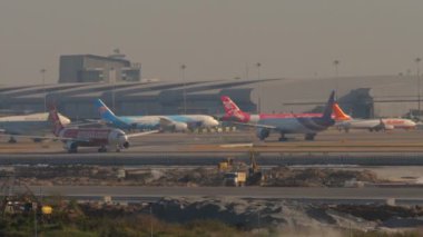 BANGKOK, THAILAND - JANUARY 19, 2023: Commercial jet Airbus A330, HS-XTI of AirAsia accelerating for takeoff at Suvarnabhumi Airport. Passenger flight departure. AirAsia X Malaysian low cost airline