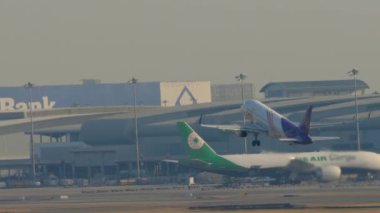 BANGKOK, THAILAND - JANUARY 21, 2023: Shot of plane Airbus A320 of Thai Smile takeoff and climbing at Suvarnabhumi Airport. Passenger flight departure, side view. Remove landing gear
