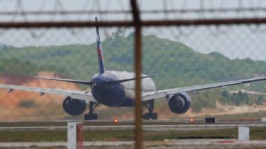 PHUKET, THAILAND - 30 HAZİRAN 2023: Phuket havaalanındaki pist üzerinde, Aeroflot 'un geniş gövdeli uçağı Boeing 777, arka görüş. Uçak kalkıyor. Uçak kalkıyor. Turizm seyahati kavramı