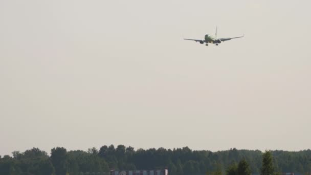 Onherkenbare Passagiersvliegtuig Nadert Landing Verlichte Zonsondergang Licht Verre Schot — Stockvideo