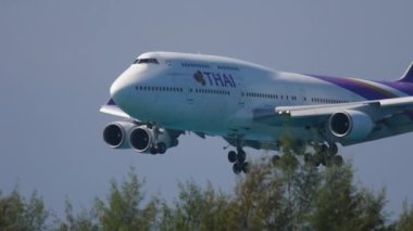 PHUKET, THAILAND - 26 Kasım 2016: Tayland Havayolları 'ndan Heavy Boeing 747 Phuket havaalanına indi. Jumbo jet yolcu uçakları, yan görüş. Turizm ve seyahat kavramı