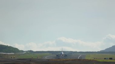 İnişten sonra fren yapan bir uçağın sinematik görüntüleri. Uçak geliyor. Spoiler ver, hızını düşür. Yolcu uçağı, Phuket Adası. Turizm ve seyahat kavramı