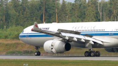 MOSCOW, RUSSIAN FEDERATION - JULY 29, 2021: Airbus A330 of Air China airlines braking after landing at Sheremetyevo airport SVO. Aviation and travel concept