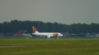 AMSTERDAM, THE NETHERLANDS - JULY 24, 2017: Airbus A319, CS-TTC of TAP Air Portugal taxiing at Schiphol Airport. Airliner on the airfield, taxiway. Tourism and travel concept