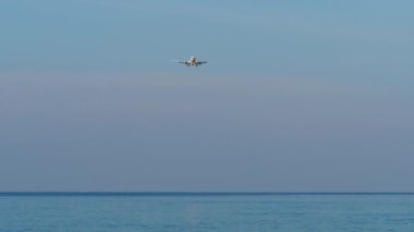 Ticari jet uçağı iniş pisti, mavi gökyüzü, düşük ihtimal. Uçan bir yolcu uçağının görüntüsü. Turizm ve seyahat kavramı