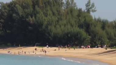 Phuket Havaalanı 'nın yakınındaki Mai Khao plajındaki insanlar. Denizin üzerinde uçan uçağa bakan kişi, seyahat ve aktif yaşam tarzı konsepti