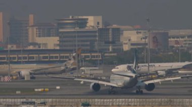 BANGKOK, THAILAND - 01 Mart 2023: Suvarnabhumi Havalimanı 'na indikten sonra Cathay Pacific Airbus A350 fren yapıyor. Uçak geliyor. Hava yolculuğu. Spoiler hazır.