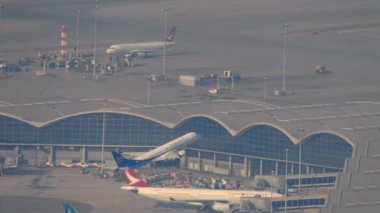 HONG KONG - 09, 2019: Embraer 190 of Mandarin Airlines, Hong Kong havaalanından havalandıktan sonra tırmanıyor. Büyük havaalanının panoramik görüntüsü