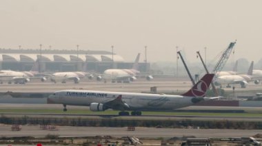BANGKOK, THAILAND - 01 Mart 2023: Airbus A330-303, Türk Havayolları TC-JOI, Suvarnabhumi Havaalanı, yan görüş. Uçak geliyor, dokunuyor, fren yapıyor. Spoiler hazır..