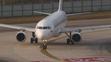 PHUKET, THAILAND - 13 Şubat 2023: Jet yolcu uçağı Airbus A320, Phuket havaalanındaki pistte HS-VKT. Uçak havaalanında taksicilik yapıyor. Beneklenme