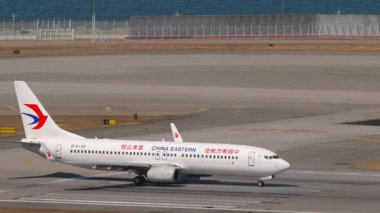 HONG KONG - 28 Ocak 2025: Boeing 737, B-6149 Çin Doğu Havayolları, Chek Kap Kok havaalanı, Hong Kong, yan görüş. Uçak kalkıyor. Seyahat kavramı