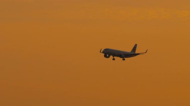PHUKET, THAILAND - FEBRUARY 05, 2025: Jet uçağı Çin Doğu Havayolları günbatımında yüksek irtifada uçuyor, küresel seyahat ve lüks havacılığı simgeliyor