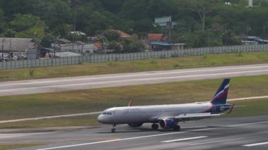 PHUKET, THAILAND - 12 Mart 2025: Airbus A321, RA-73704 Aeroflot havaalanında taksicilik. Uçak pistte, yan görüş. Seyahat kavramı