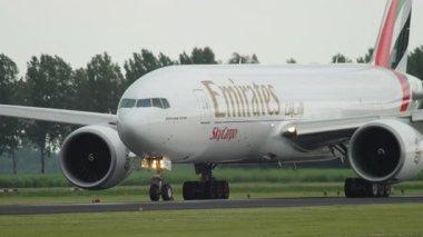 AMSTERDAM, NETHERLANDS - 25 Temmuz 2017: geniş gövdeli uçak havaalanında. Emirates kargo Boeing 777, pistte A6-EFO, orta atış..