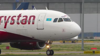 ALMATY, KAZAKHSTAN - 11 Mayıs 2024: Almaty havaalanında taksicilik yapan Arystan uçakları vuruldu, uçtu. Havaalanında bir uçak var. Seyahat konsepti. Beneklenme