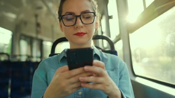 Public Transport Slow Motion Woman Glasses Tram Using Smartphone Chatting — Stok video