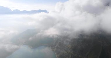 Bluemlisalp dağıyla Oeschinensee Gölü 'nün bulutların arasından havadan görünüşü. İsviçre Alpleri, Kandersteg. İsviçre.