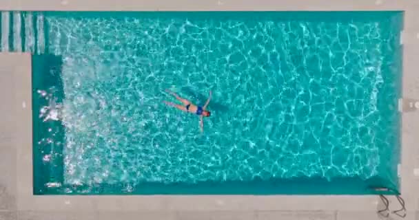 Top View Woman Blue Swimsuit Lying Her Back Pool Relaxing — Stockvideo